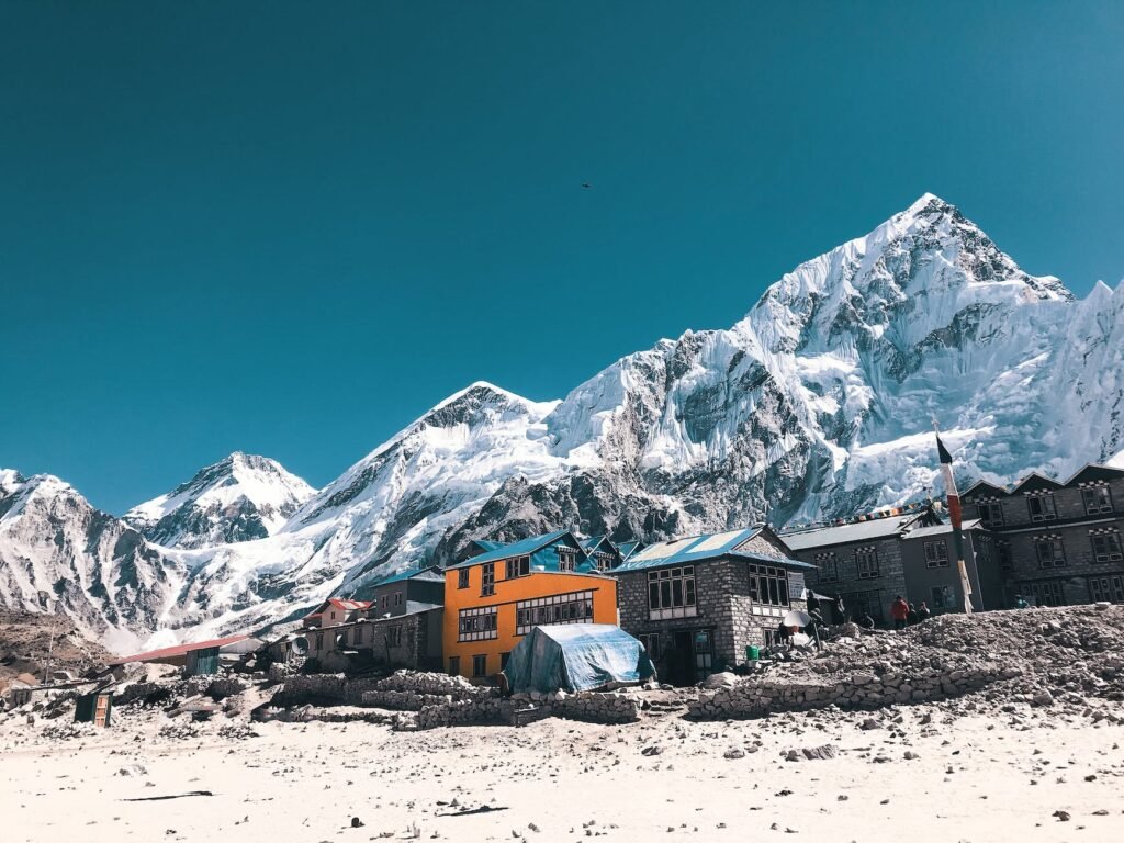 orange and gray houses near snow covered mountain